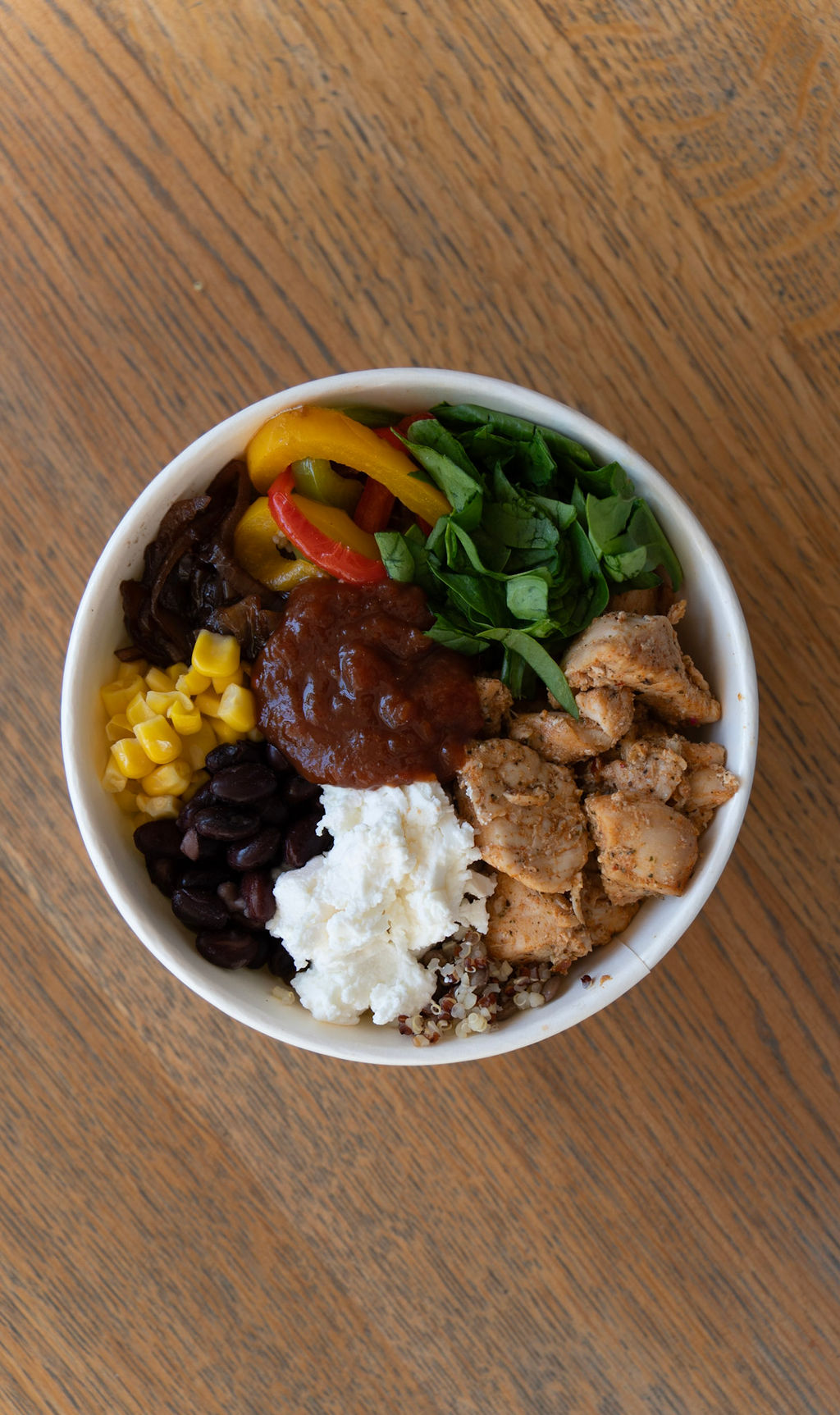 Mexican-style grain bowl with chicken, feta, corn and beans