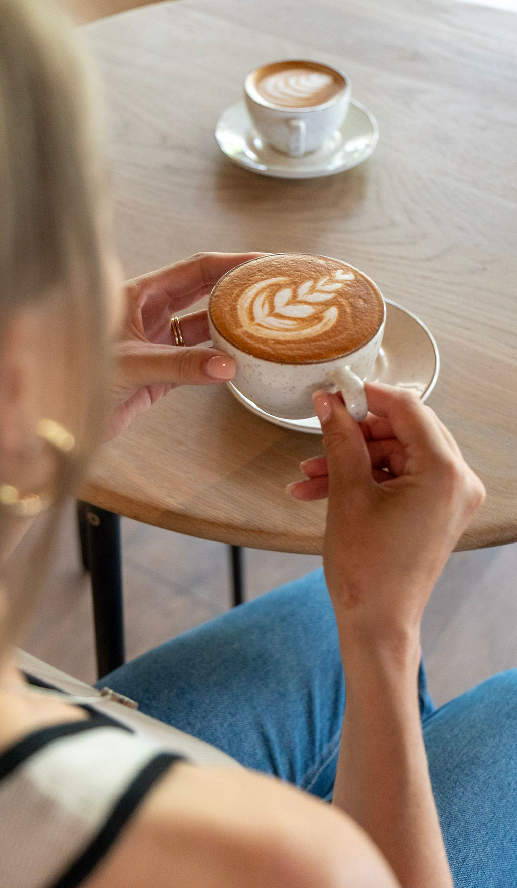 Customer enjoying a latte at Rocco & Riley