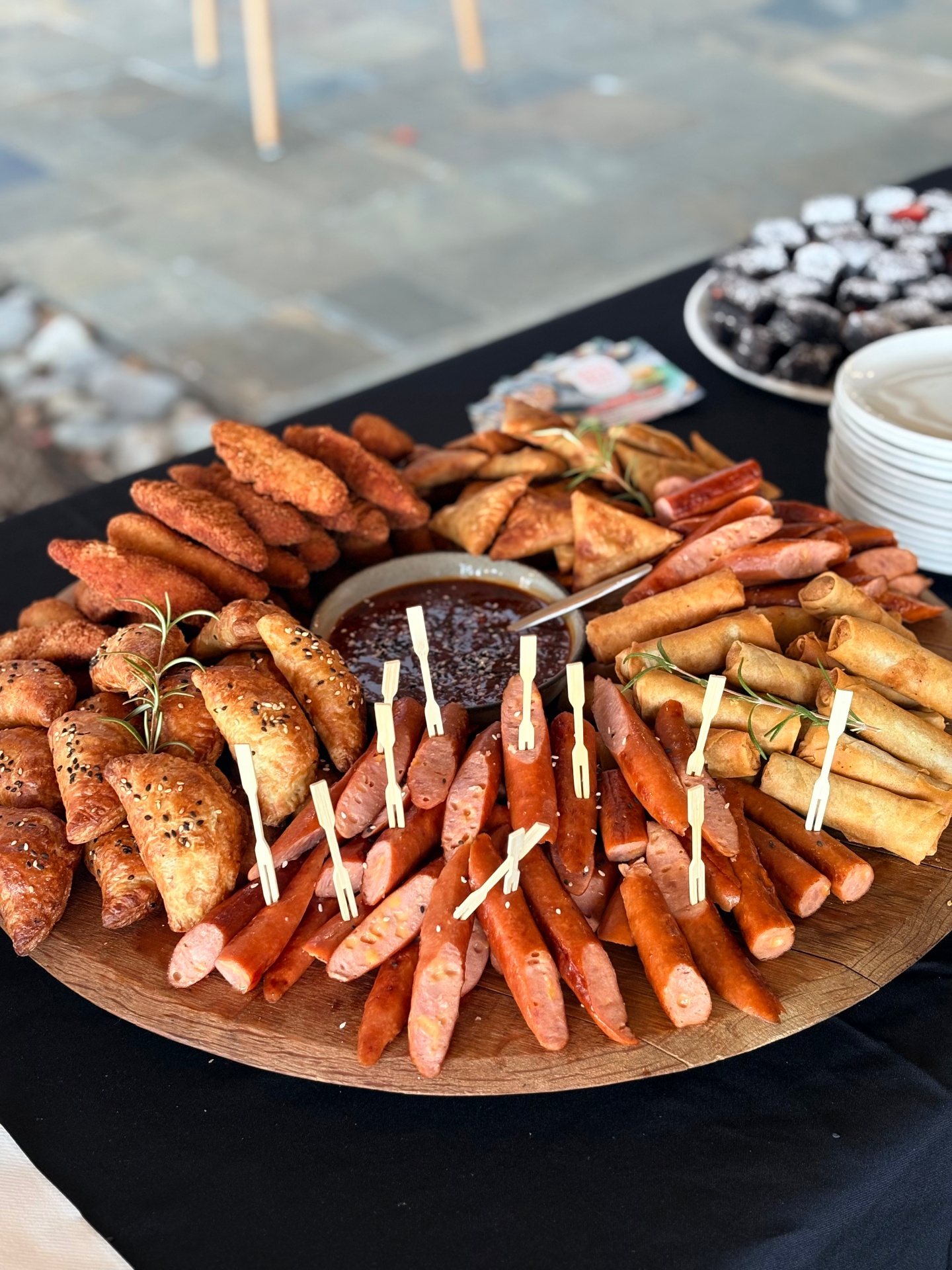 Savoury catering platter with samosas, spring rolls and cocktail sausages