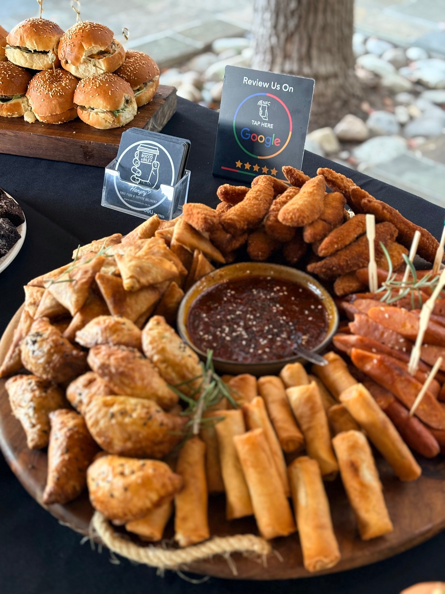 Boardroom catering setup with multiple platters and sliders