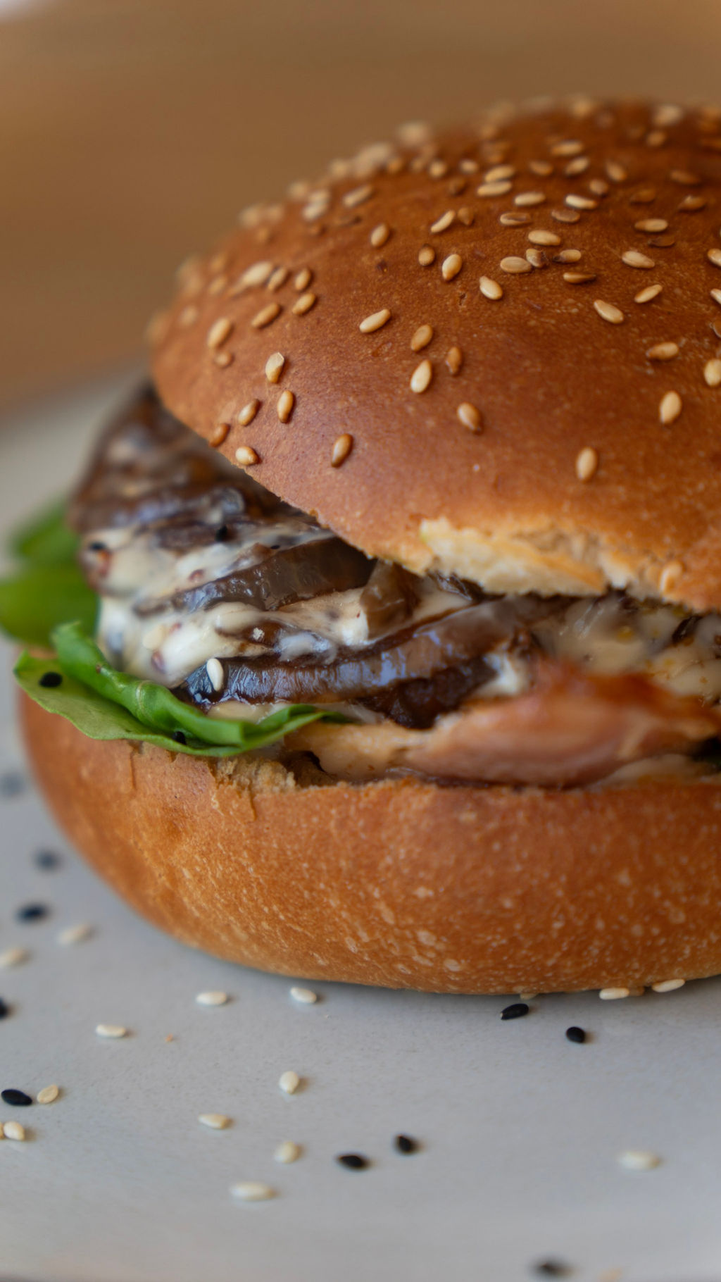 Sesame bun smashburger with mushroom and greens